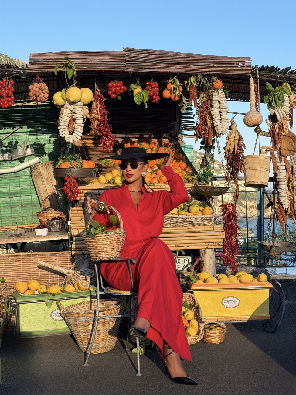 TORYV TRIBE editorial — the scarlet shirt dress worn at a coastal market stall